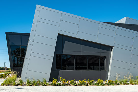 Modern building with angular profile set against a clear blue sky.